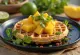 Fusionsvaffel serveret med kokosmælk, revet ost, mango og chiliflager